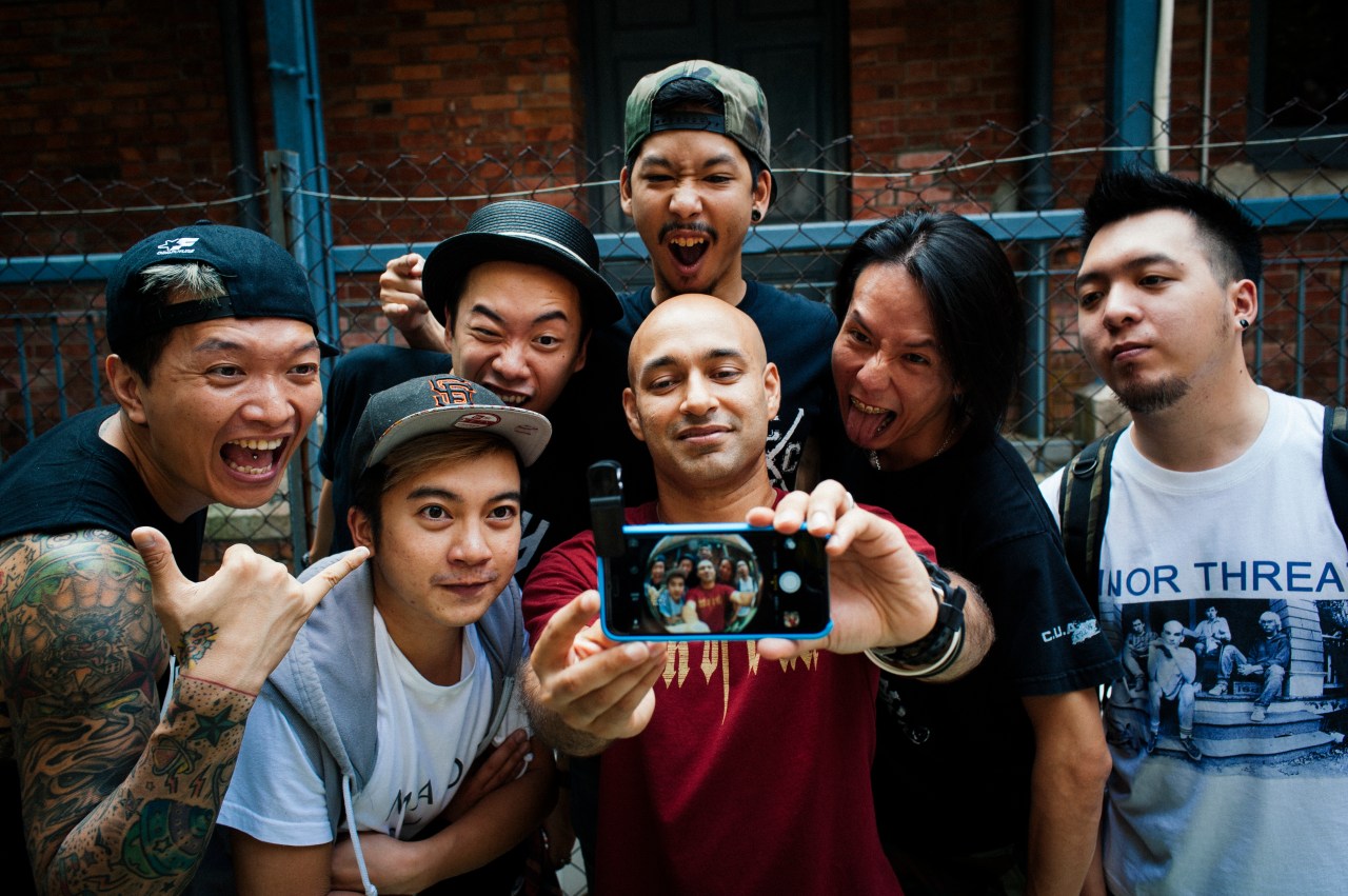 Past and current members of King Ly Chee pose for a selfie.