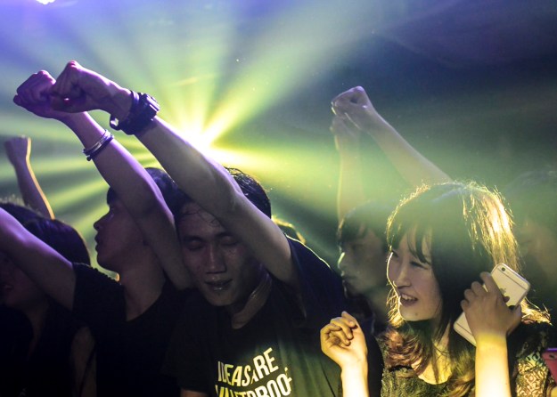 1. Young fans enjoy the music during a show. 2. King Ly Chee on stage during a show. The band has been a major player in the local Hong Kong music scene for more than 15 years.