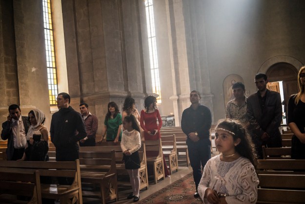 1. Guests attend the wedding at Ghazanchetsots church. 2. Construction workers build a cluster of brand new apartment buildings in Stepanakert.