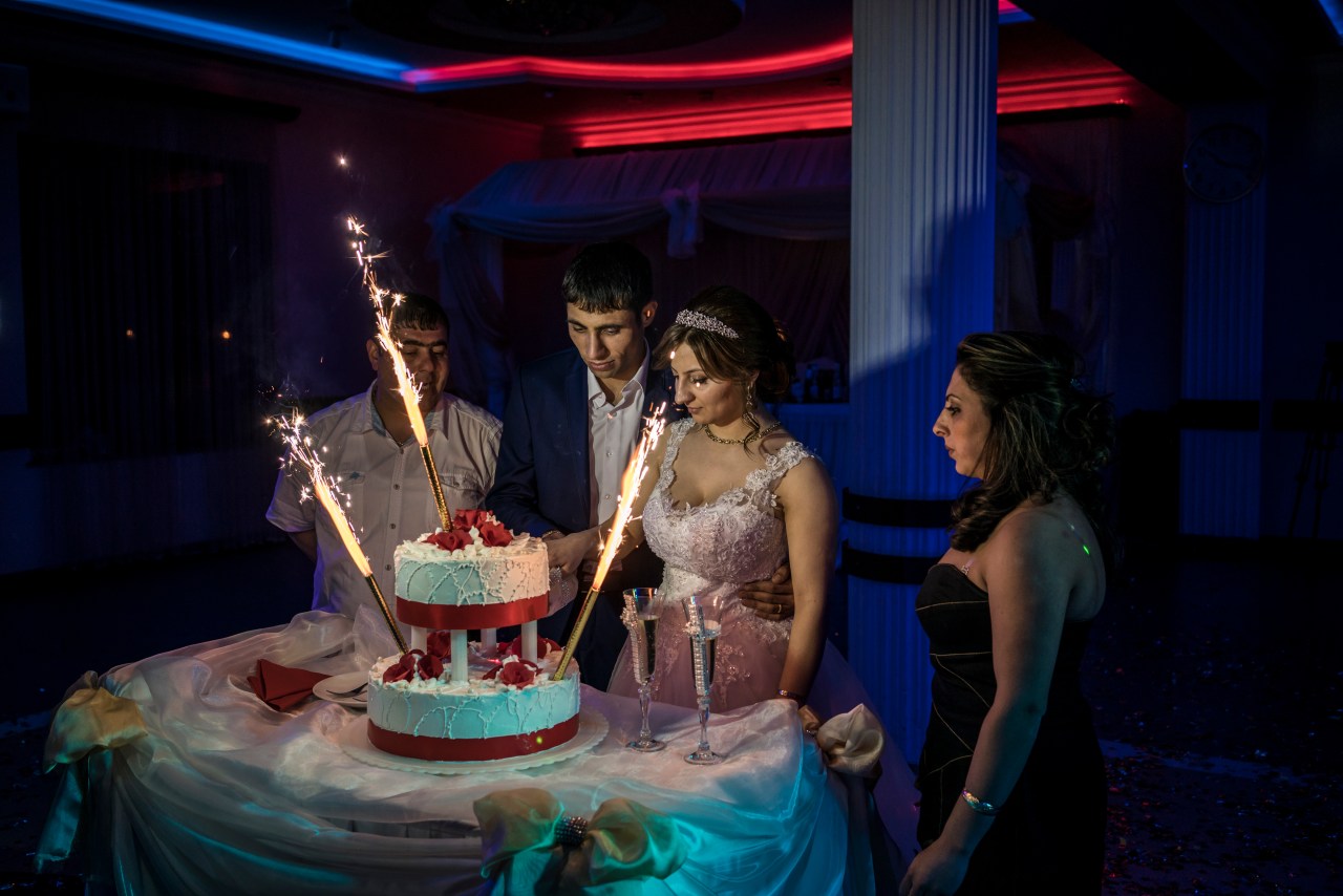 Davit Simonyan and Shogher Hovsepyan cut the cake at their wedding reception.