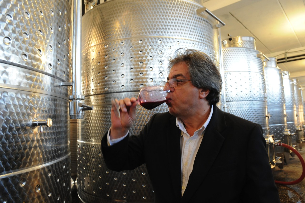 Winemaker Vahe Keushguerian samples Areni straight from the fermentation tank. Photo by: Karen Minasyan