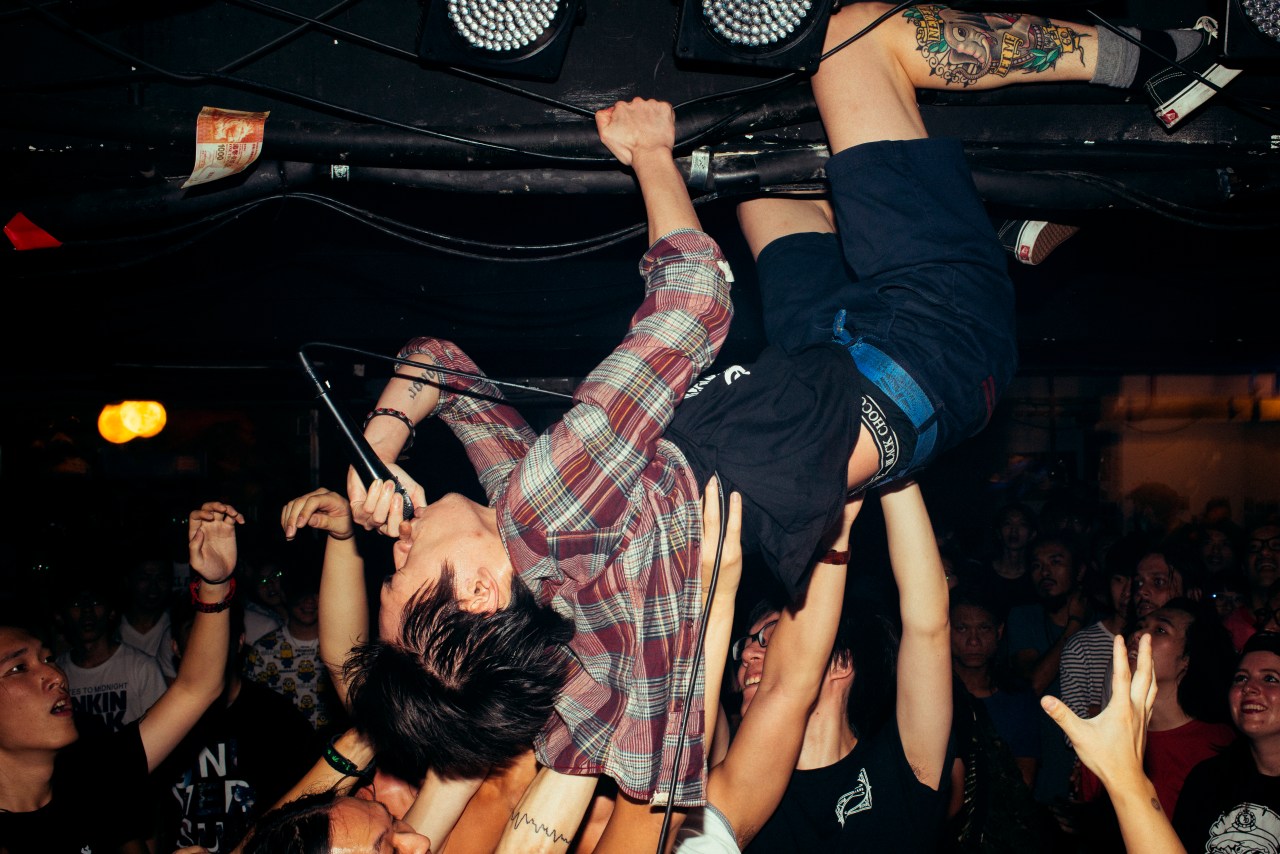 The lead singer of the melodic hardcore band The Priceless Boat hangs from the ceiling during a show at Hidden Agenda.