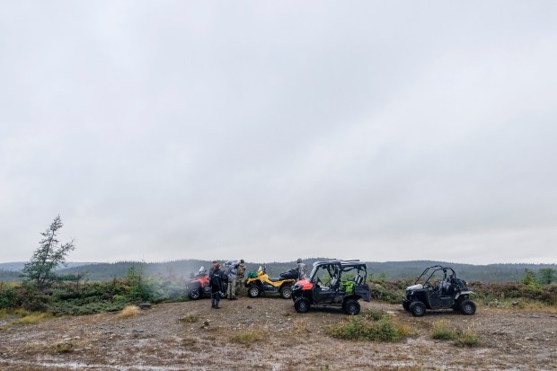 The team with their ATVs while hunting.