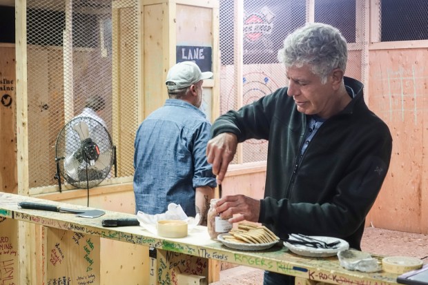 Digging into some pickled pork tongue while Dave attempts to throw an axe.