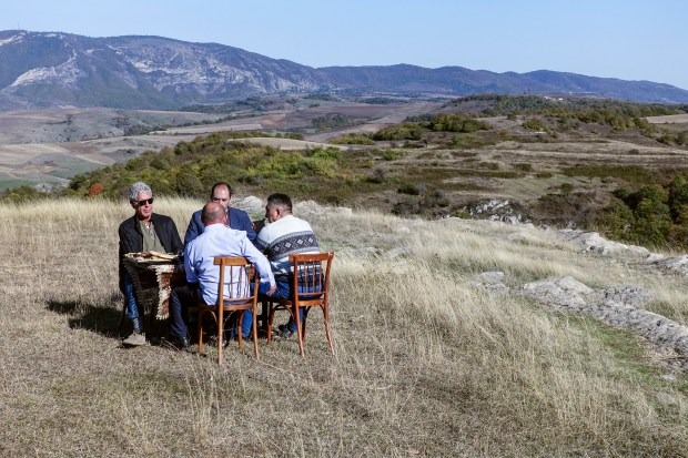 Tony and the men sitting on a hillside in Nagorno-Karabakh.