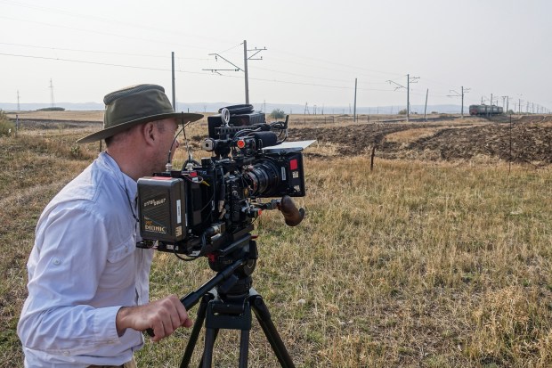 Director of Photography Zach Zamboni films a train in the countryside of Armenia.