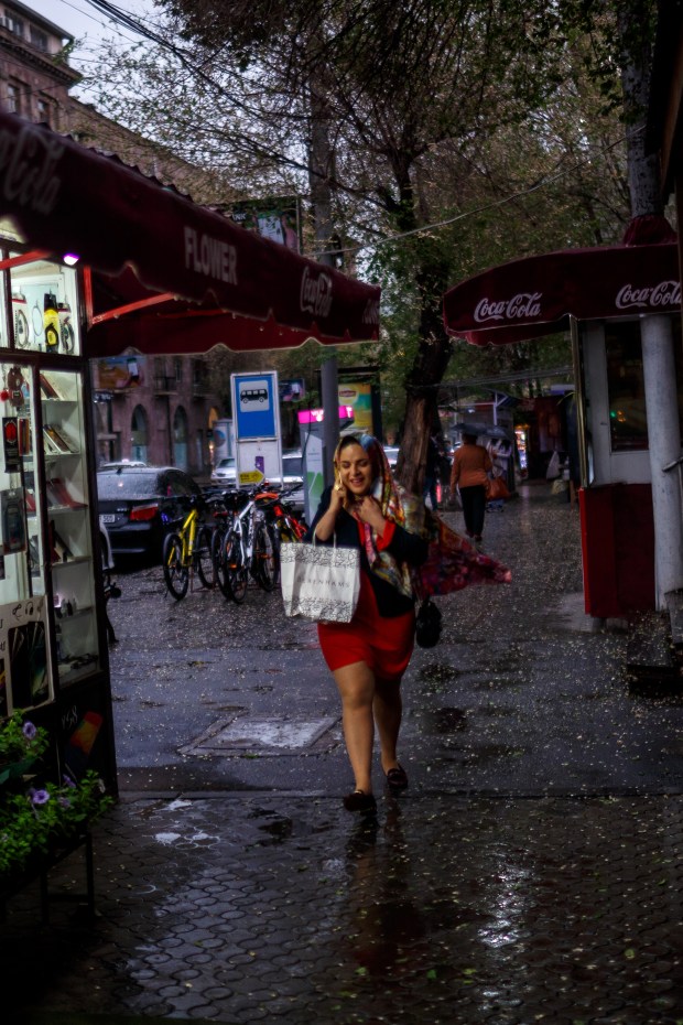A woman walks through the rain in Yerevan.