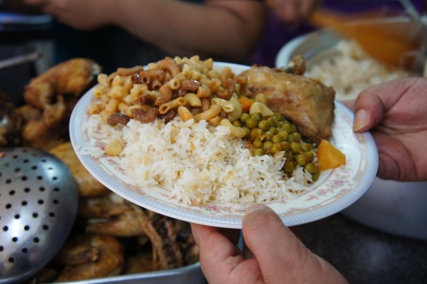 Refugees cook and share a meal together at the communal kitchen.