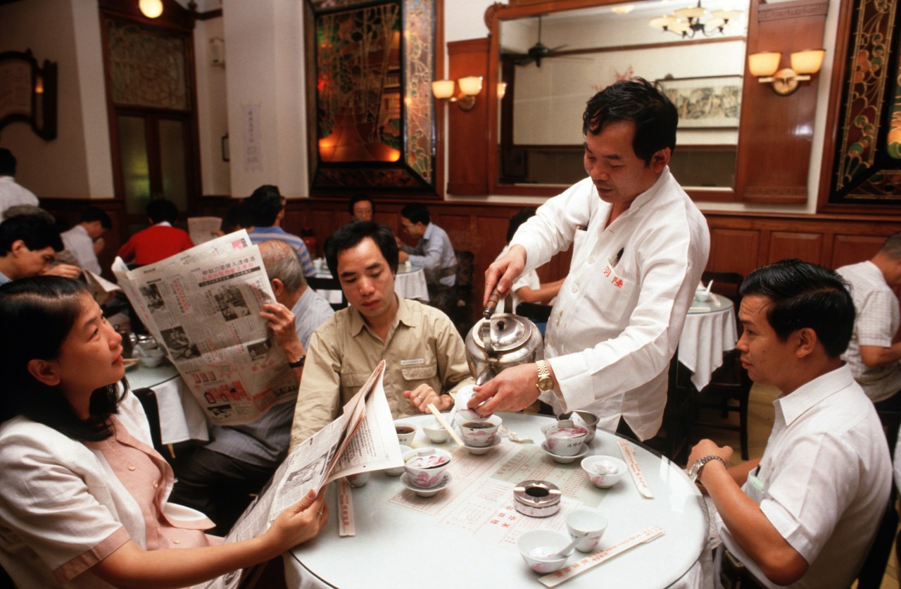 A waiter serves tea at Lukyu Tea House, Hong Kong. Photo by Peter Charlesworth/LightRocket via Getty Images.