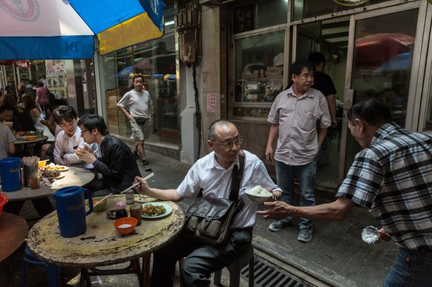 Customers at a dai pai dong. Photos by Anthony Wallace/AFP/Getty Images.