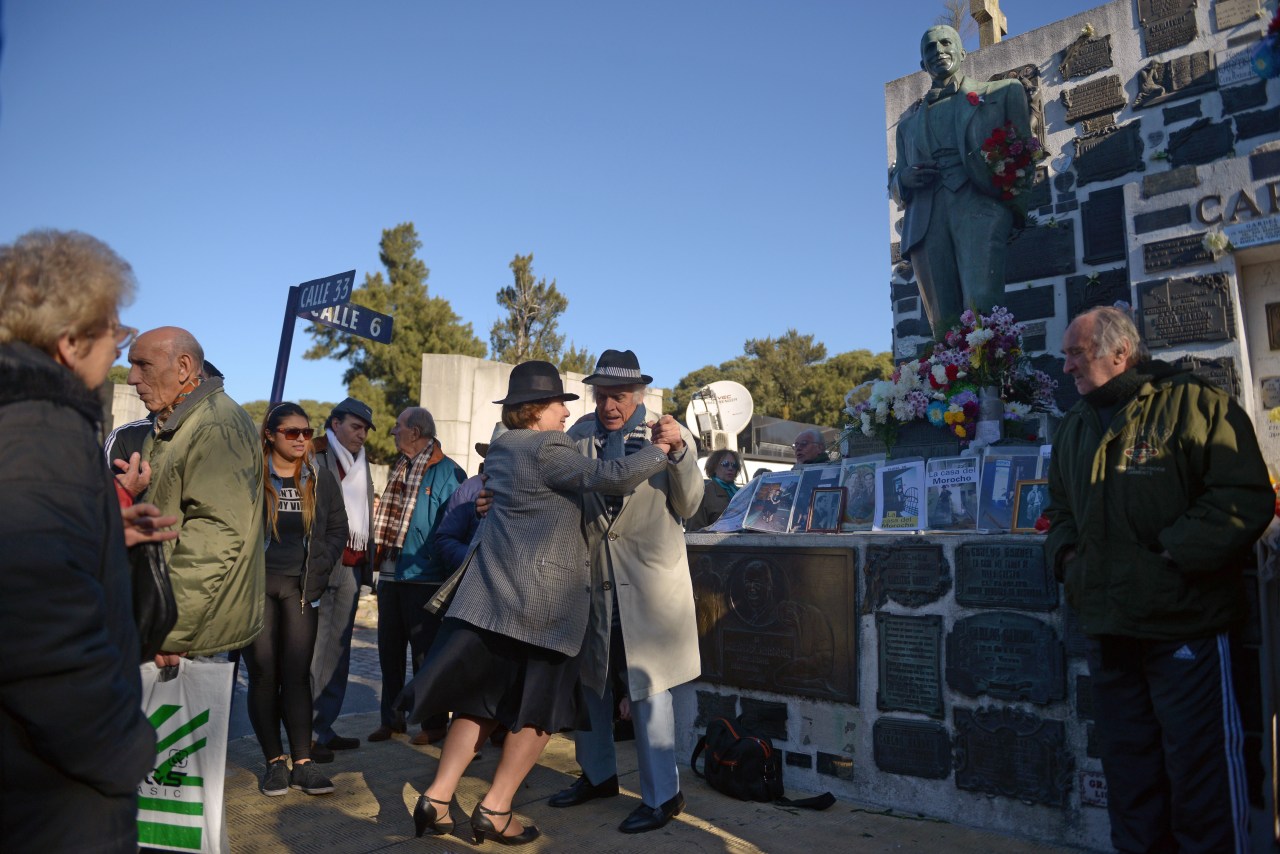 A couple dances by Gardel's grave in Buenos Aires. Photo by EITAN ABRAMOVICH/AFP via Getty Images