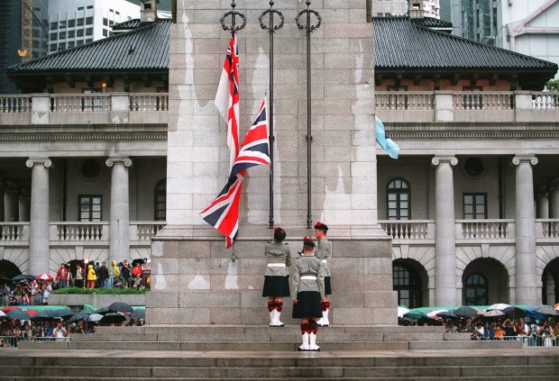 Soldiers lower the British flag prior to the return of Hong Kong to Chinese rule. Photo by Stephen Shaver/AFP via Getty Images.