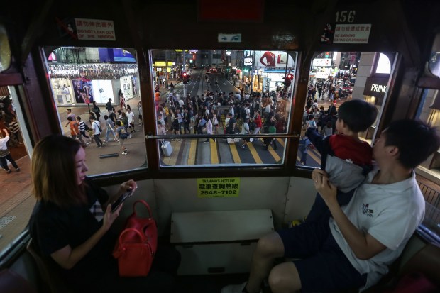 Passengers in a tram in Hong Kong. Photo by Vivek Prakash/AFP/Getty Images.