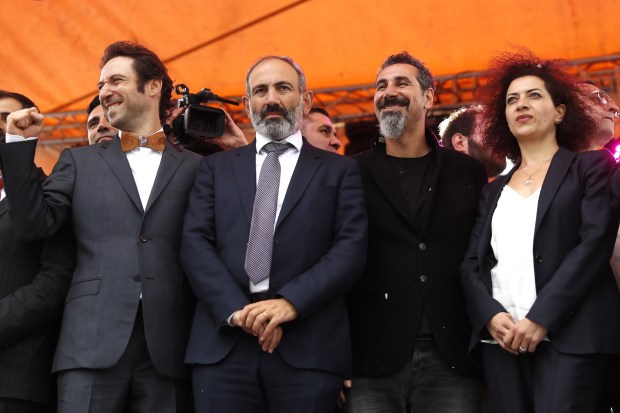 Pashinyan (second left), singer Serj Tankian (second right), and Pashinyan's wife Anna Akopyan (right) celebrate Pashinyan's election. Photo by Artyom Geodakyan/TASS via Getty Images.