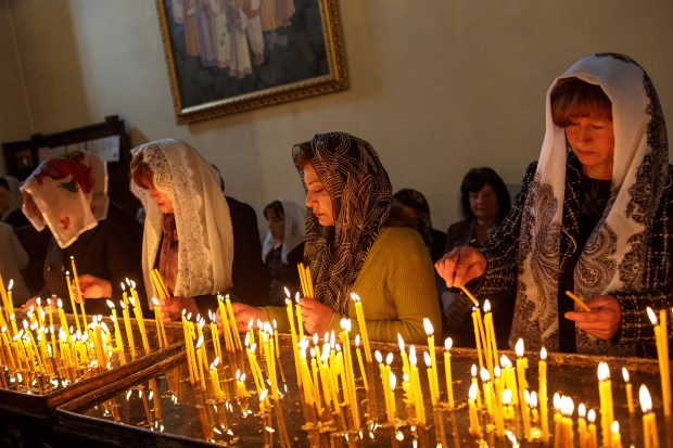 Worshipers pray and light candles at the Etchmiadzin Cathedral.