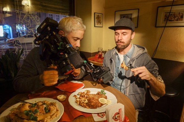 Jeremy Leach films local crew member Dominik with schnitzel at Zum Schusterjungen. Photo by Josh Ferrell.