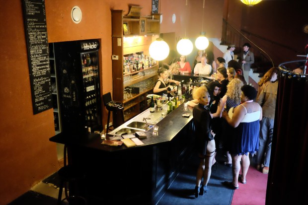 People crowd around the bar at Delphi theater during a Berlin Burlesque Week event.