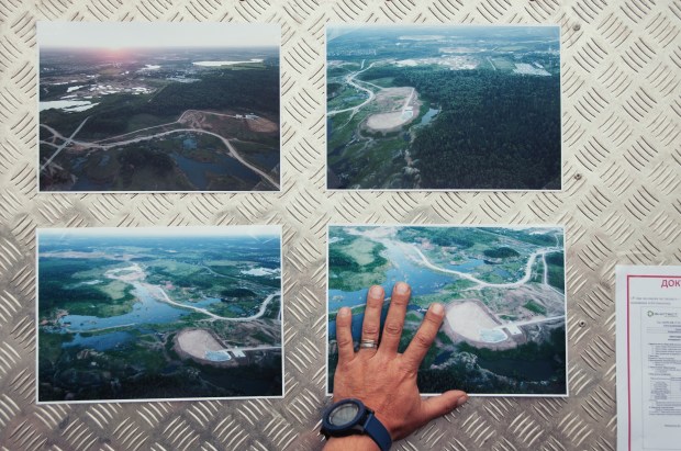 A volunteer hangs pictures of the dump site.