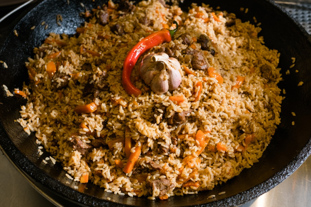 Plov—rice steamed in stock with meat and vegetables. Photo by Golubovystock/Shutterstock.
