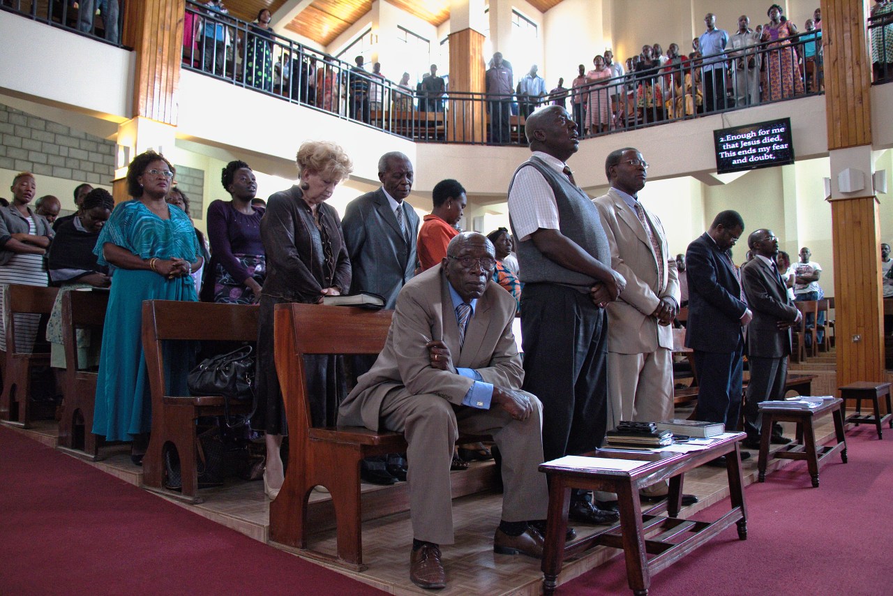 Churchgoers stand in prayer during a Sunday service at the Friends International Centre in Nairobi, Kenya.