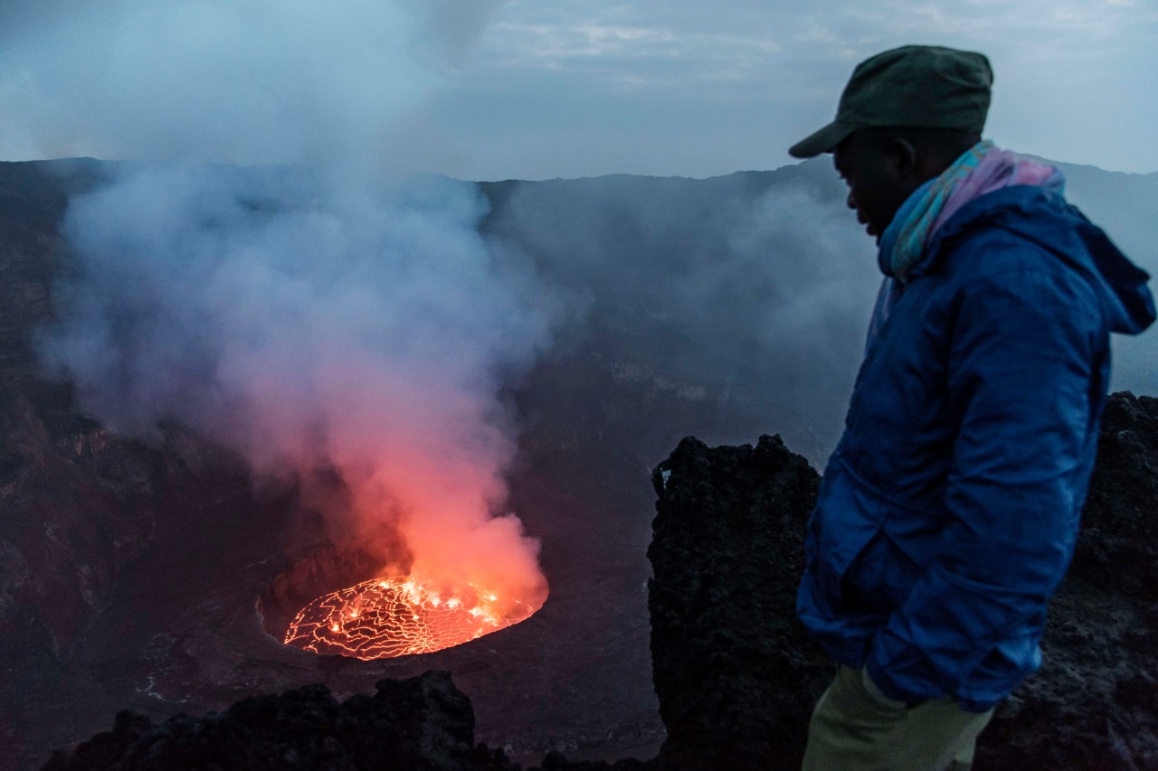 A ranger looks at the main crater of Mount Nyiragongo. Photo by Thierry Falise/LightRocket via Getty Images.