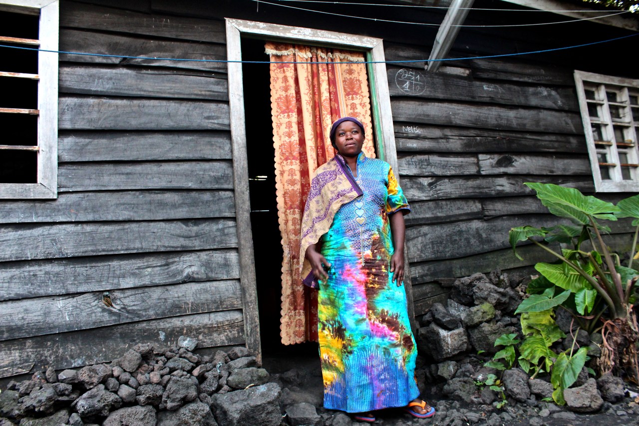 Kavira Ngesera, 41, standing in front of her home in Goma that she and her husband spent saving years to build.