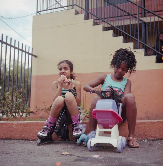 1. Yennis, left, and Drényla play outside their home in Overtown. 2. Pedestrians under the intersection of the I-395 and I-95 highway.