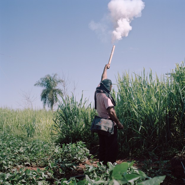 1: A man shoots a firecracker to alert the population that a fumigation is about to place. 2: Many in La Terza Cué community have lost their jobs.