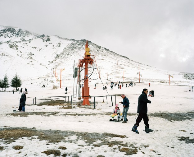 1: Dated skis at the summit of Jebel Oukaimeden. 2: People skiing and sledding down the slopes at the resort.