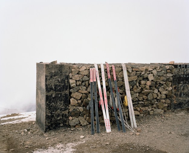 1: Dated skis at the summit of Jebel Oukaimeden. 2: People skiing and sledding down the slopes at the resort.