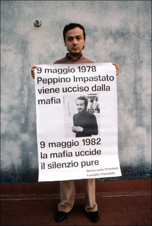 A man holds a sign for his brother, a victim of the mafia. Photo by Eric Vandeville/Gamma-Rapho via Getty Images