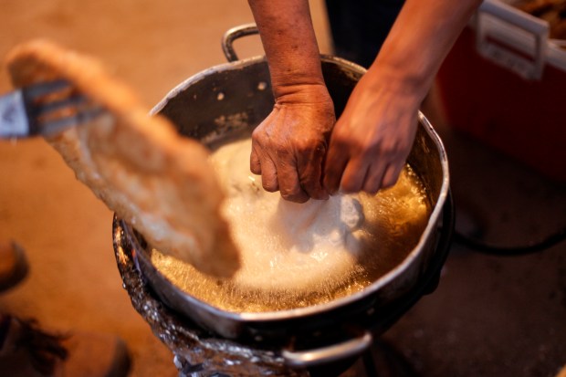 A woman making frybread. Photo by Danita Delimont via Getty Images.