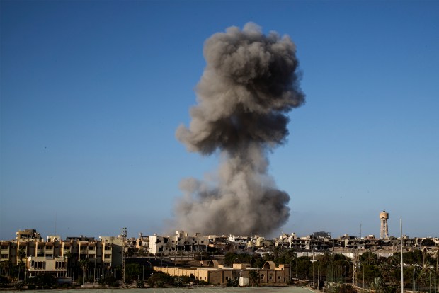 Smoke rise after an airstrike in Sirte during fighting with the Islamic State (IS) in September of 2016. Photo by Fabio Bucciarelli/AFP via Getty Images.