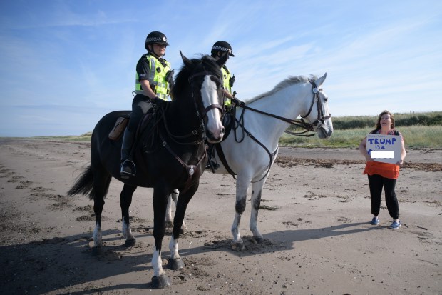 Godley protesting Trump on a beach near Trump Turnberry Luxury Collection Resort during the U.S. President's visit to the United Kingdom. Photo by Leon Neal/Getty Images.