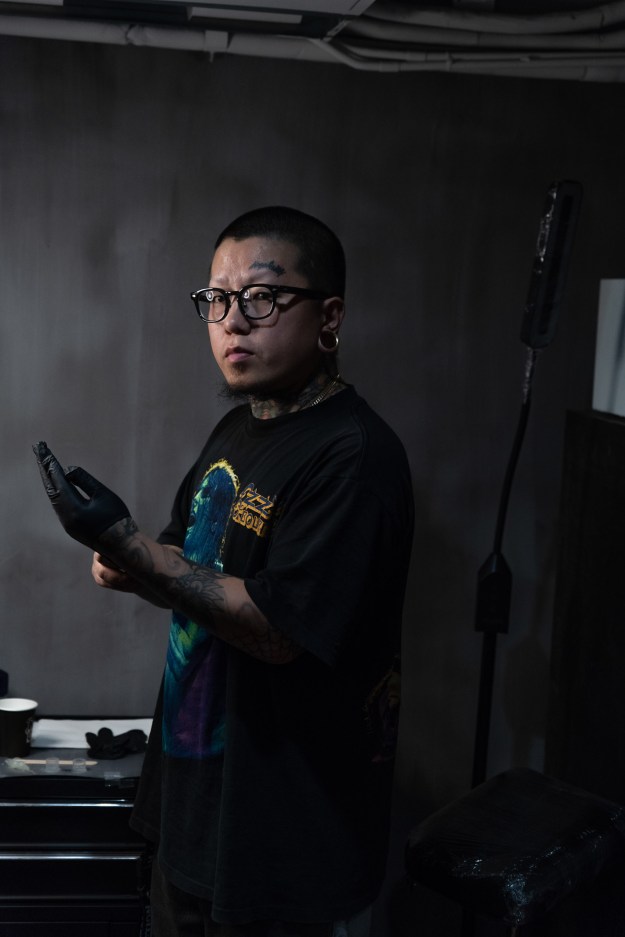 1. July, the manager of the Shanghai Tattoo, poses on the terrace of her studio. 2. Da Fei works at Shen Tattoo Studio and specializes in freehand anime.