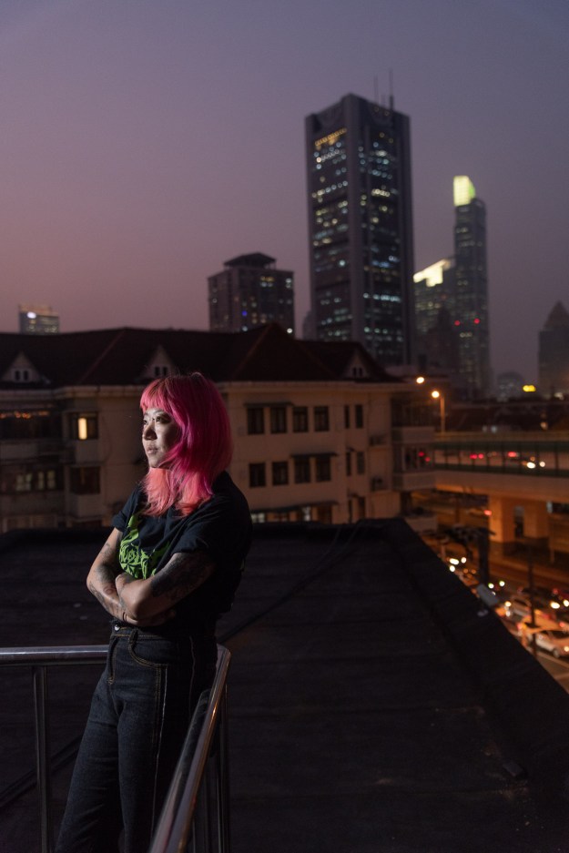 1. July, the manager of the Shanghai Tattoo, poses on the terrace of her studio. 2. Da Fei works at Shen Tattoo Studio and specializes in freehand anime.