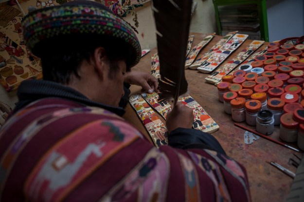 1: Marcial Berrocal paints in his workshop in the city of Ayacucho. 2: Porfirio Ramos, a Saruha-based artisan, paints in his workshop.